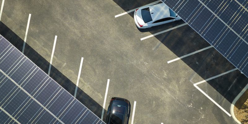 Solar panels installed over parking lot for parked cars for effective generation of clean energy