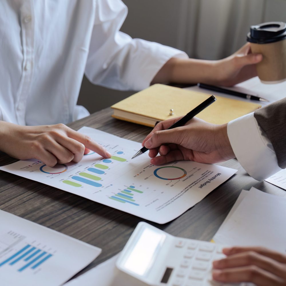 Teamwork of business people discuss and use calculator for finance paperwork data in office Teamwork of business people discuss and use calculator for finance paperwork data in office